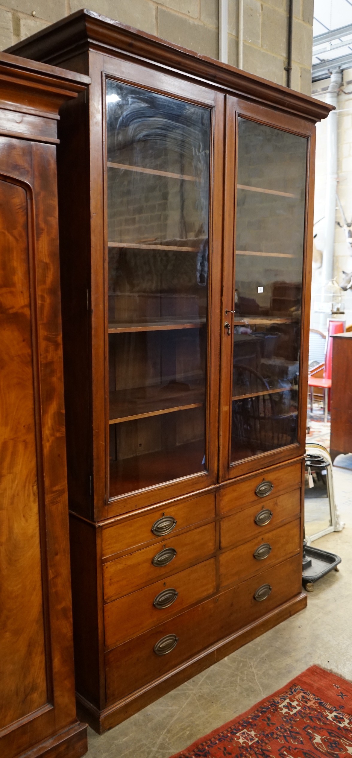 A late Victorian glazed mahogany cabinet fitted seven drawers, width 128cm, depth 56cm, height 230cm